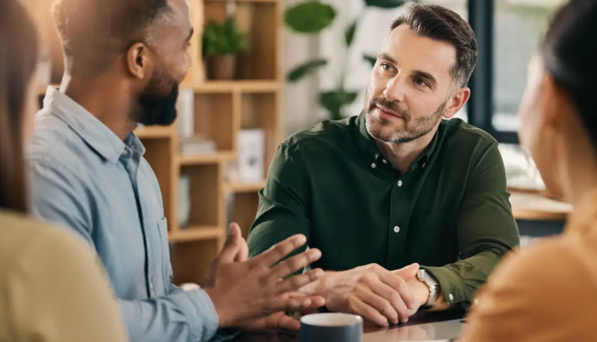 Leader listening attentively to team member during a workplace meeting